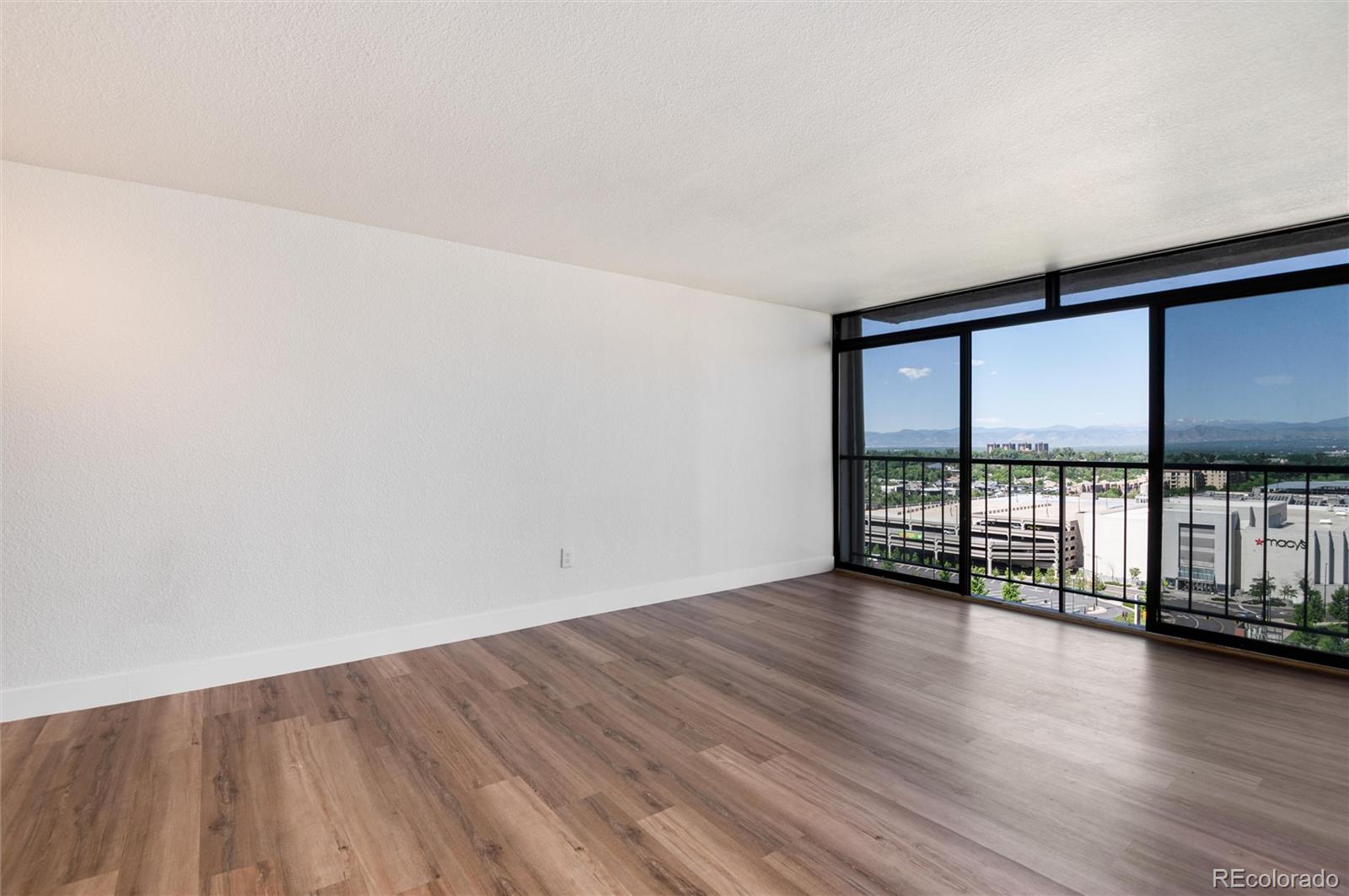 2 Adams Street, Unit 1504 Denver, CO 80206 - Photo 26 of 43 a view of an empty room with wooden floor and a window