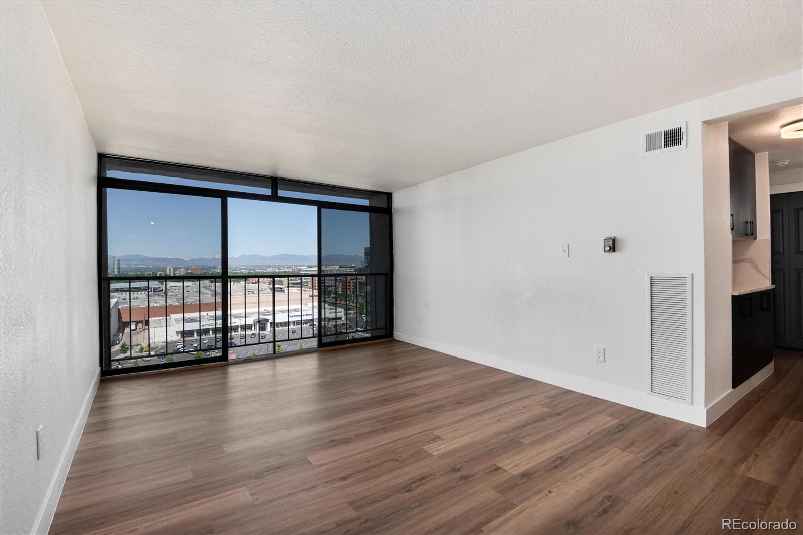 2 Adams Street, Unit 1504 Denver, CO 80206 - Photo 27 of 43 wooden floor in an empty room with a window