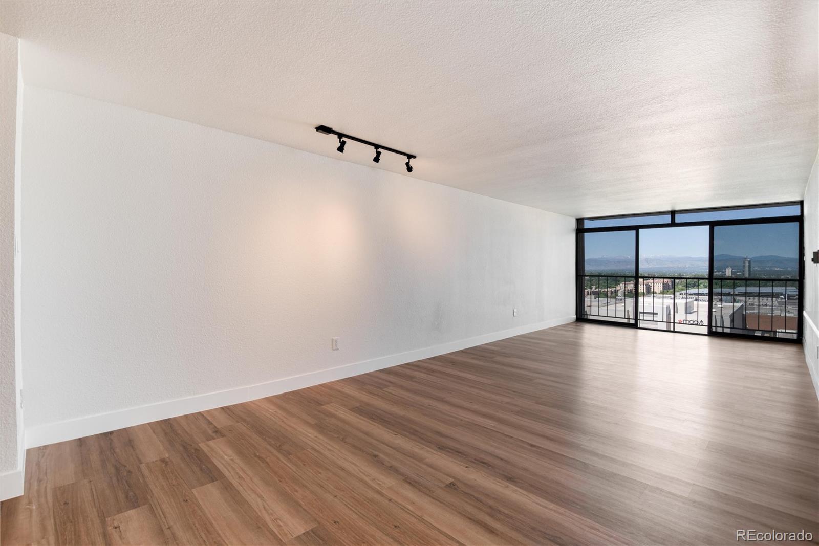 2 Adams Street, Unit 1504 Denver, CO 80206 - Photo 28 of 43 a view of empty room with wooden floor and fan