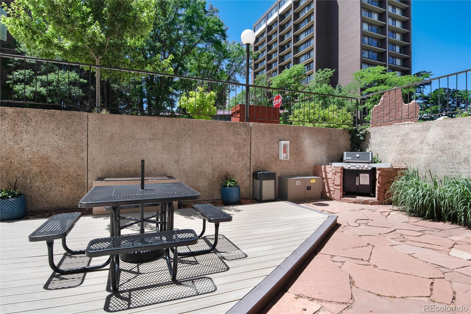 2 Adams Street, Unit 1504 Denver, CO 80206 - Photo 34 of 43 a view of backyard with seating space and trees in the background
