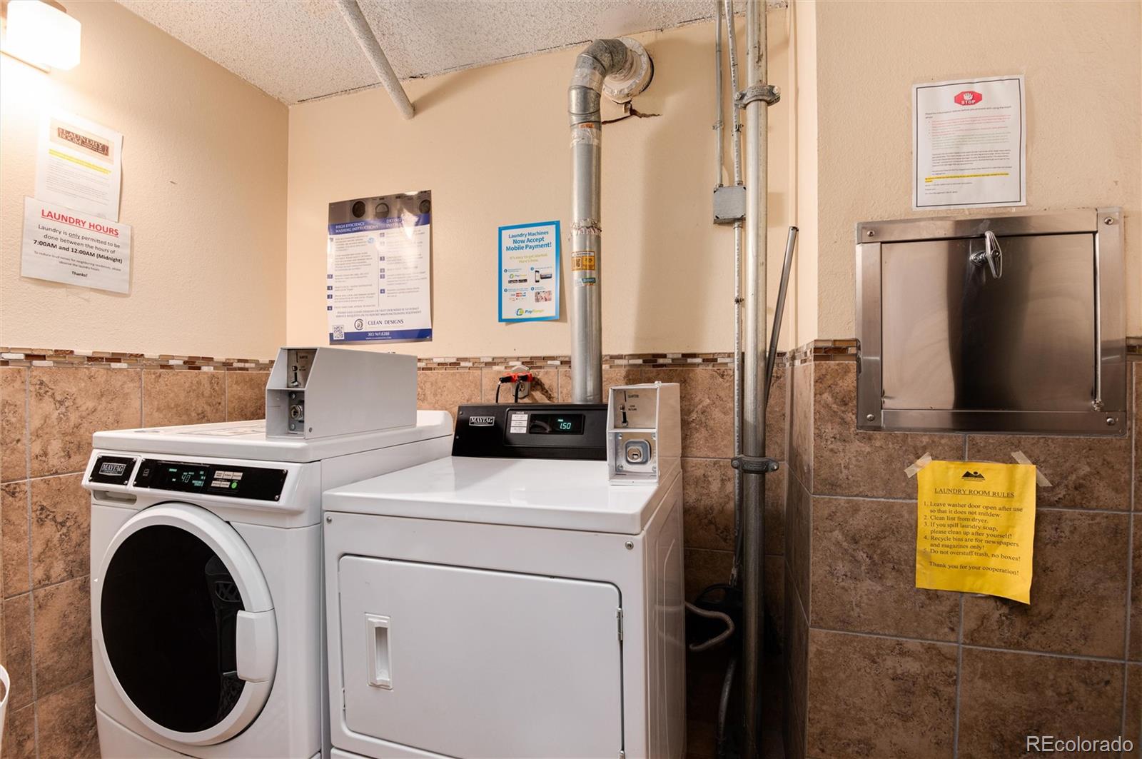 2 Adams Street, Unit 1504 Denver, CO 80206 - Photo 35 of 43 a utility room with dryer and washer