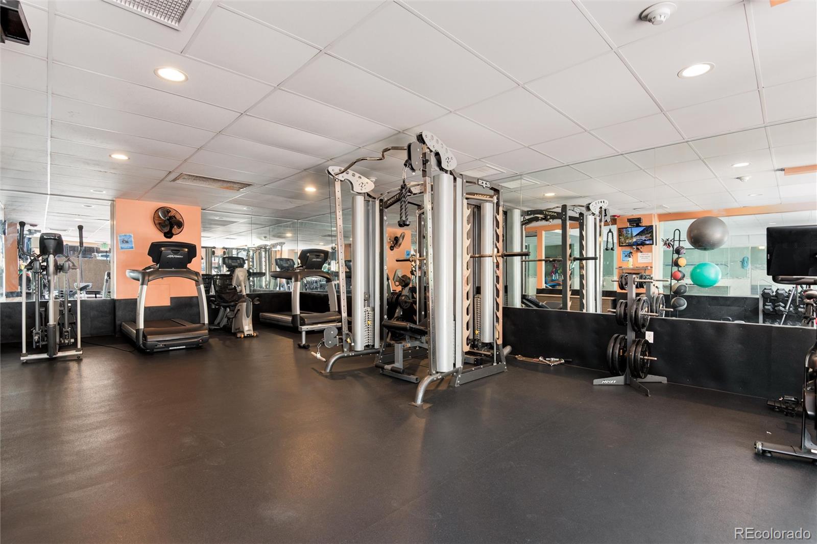 2 Adams Street, Unit 1504 Denver, CO 80206 - Photo 38 of 43 a view of a room with gym equipment and a large window