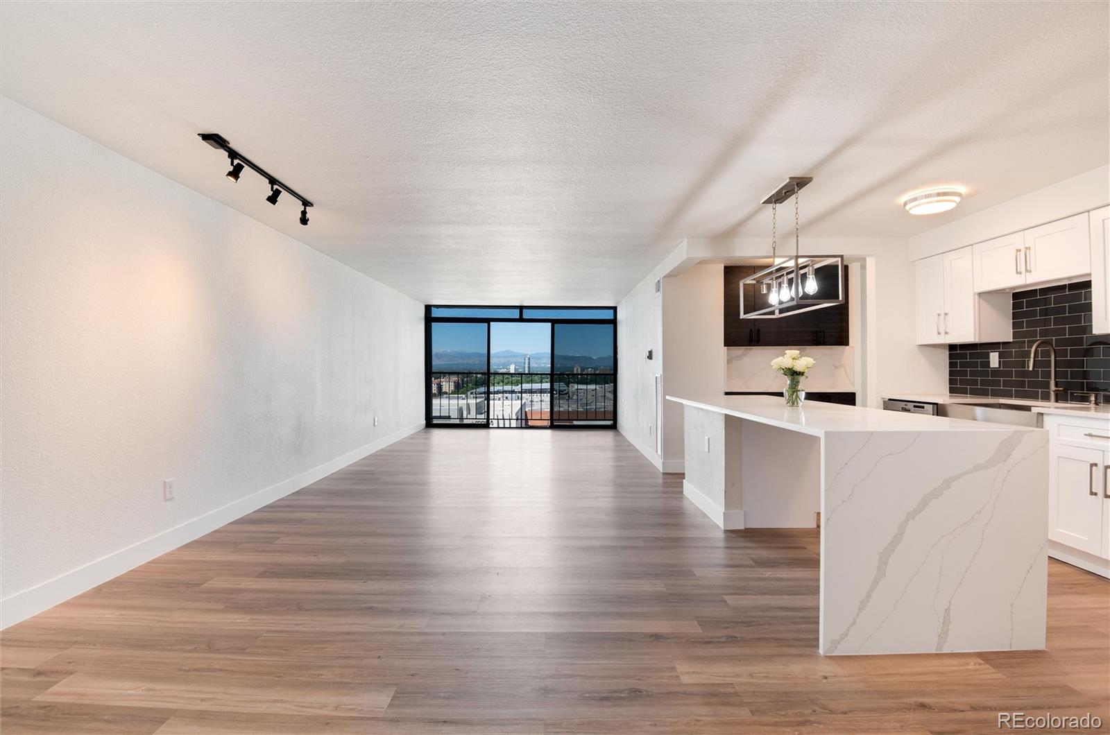 2 Adams Street, Unit 1504 Denver, CO 80206 - Photo 4 of 43 a view of kitchen with microwave and cabinets