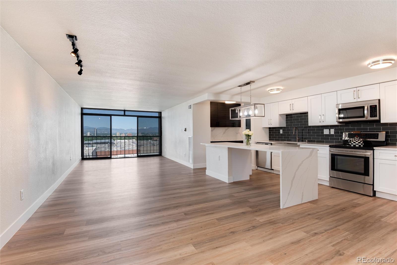 2 Adams Street, Unit 1504 Denver, CO 80206 - Photo 5 of 43 a view of kitchen with microwave stove refrigerator and cabinets