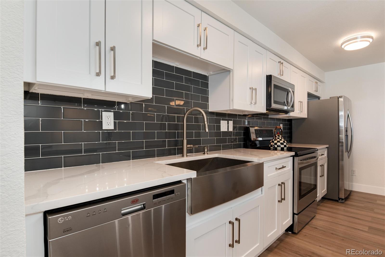 2 Adams Street, Unit 1504 Denver, CO 80206 - Photo 6 of 43 a kitchen that has a sink and a stove