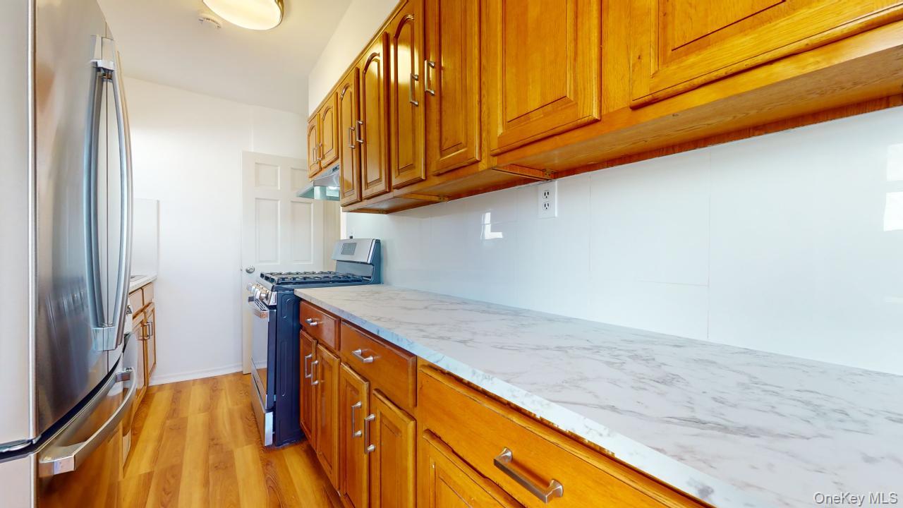 105-28 63rd Road, Unit 2 Queens, NY 11375 - Photo 12 of 30 a kitchen with a sink and cabinets