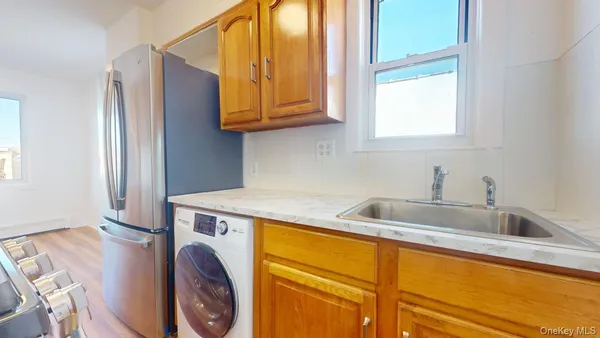 a kitchen with stainless steel appliances granite countertop a sink and a microwave