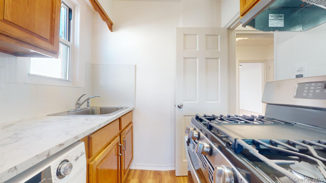 105-28 63rd Road, Unit 2 Queens, NY 11375 - Photo 15 of 30 a kitchen with granite countertop a sink and a stove