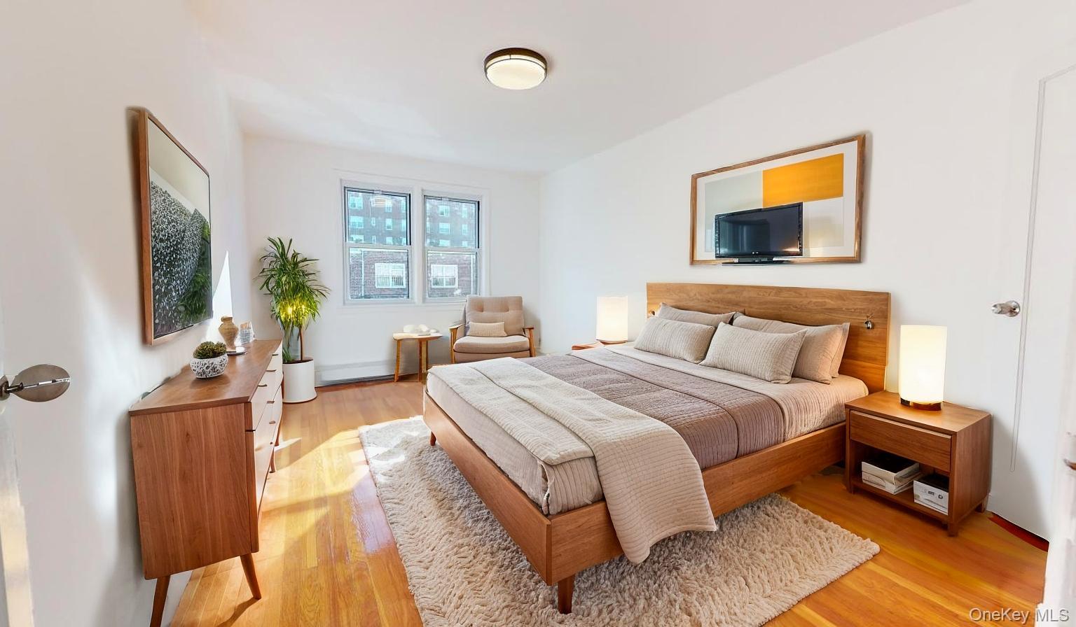 105-28 63rd Road, Unit 2 Queens, NY 11375 - Photo 16 of 30 a bedroom with a bed and wooden floor