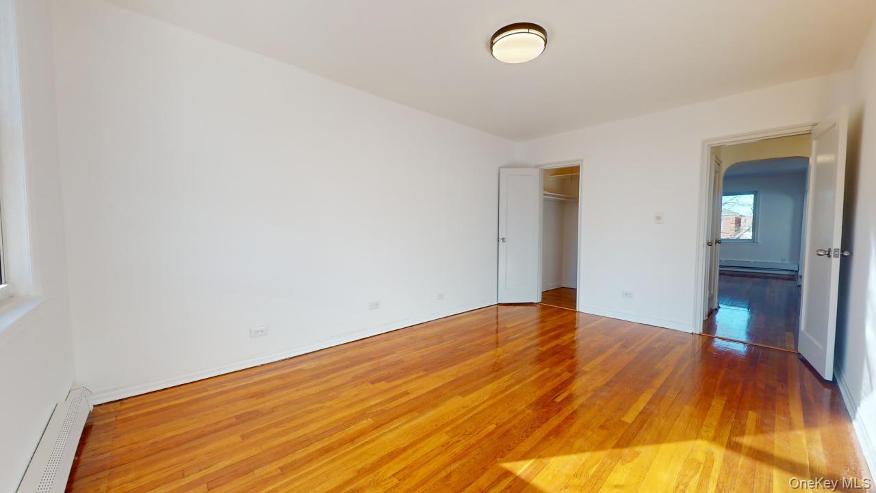 105-28 63rd Road, Unit 2 Queens, NY 11375 - Photo 19 of 30 a view of empty room with wooden floor
