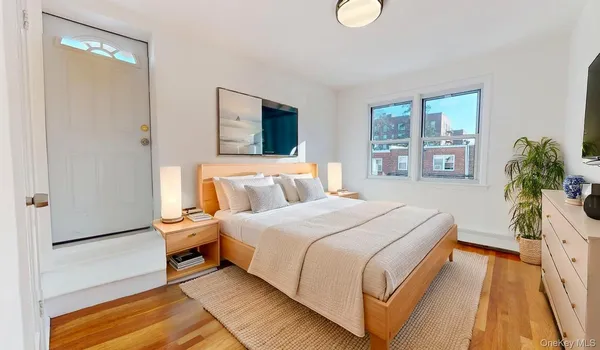 a spacious bedroom with a bed and a couch