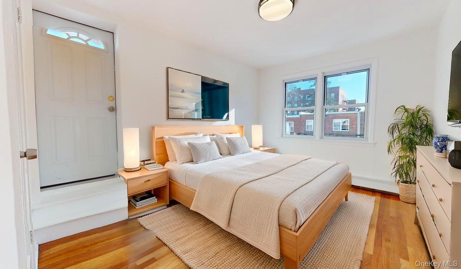 105-28 63rd Road, Unit 2 Queens, NY 11375 - Photo 21 of 30 a spacious bedroom with a bed and a couch