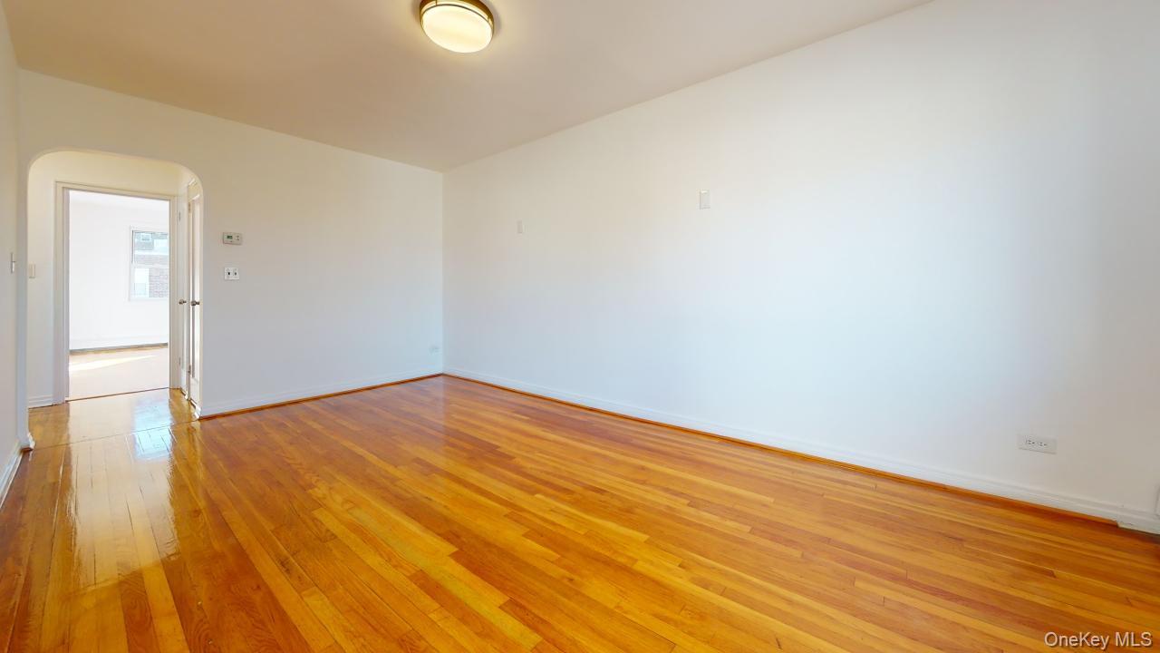105-28 63rd Road, Unit 2 Queens, NY 11375 - Photo 7 of 30 a view of empty room with wooden floor