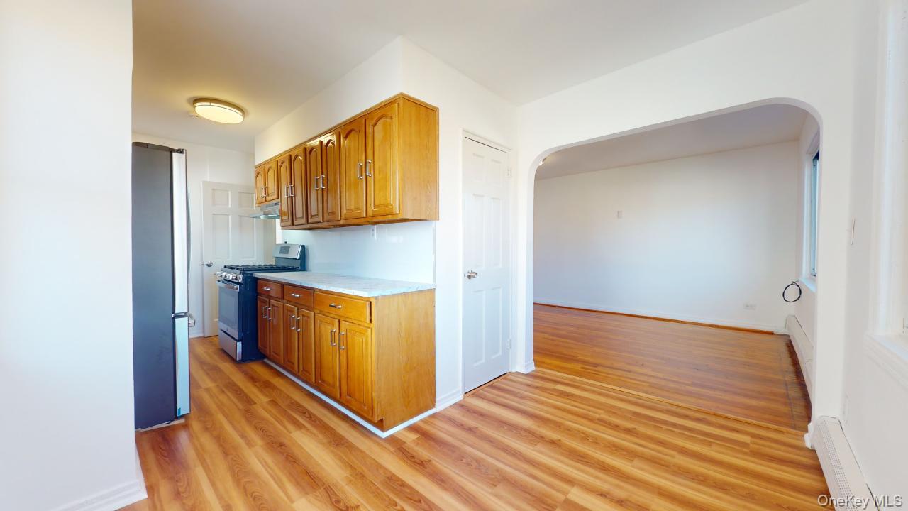 105-28 63rd Road, Unit 2 Queens, NY 11375 - Photo 10 of 30 a view of kitchen and wooden floor