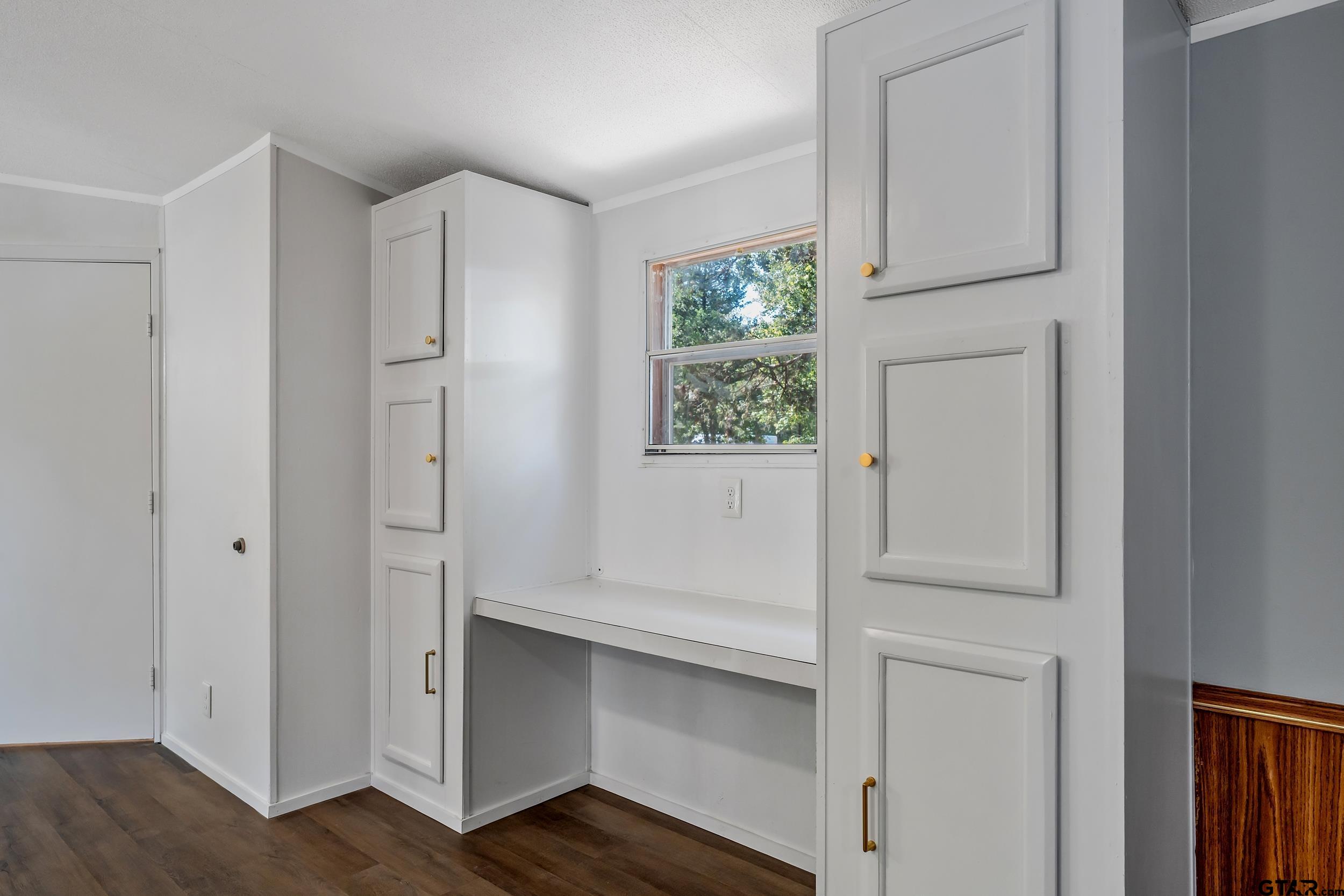 125 Ridgewood Lane Murchison, TX 75778 - Photo 11 of 46 a view of an empty room with wooden floor and a window
