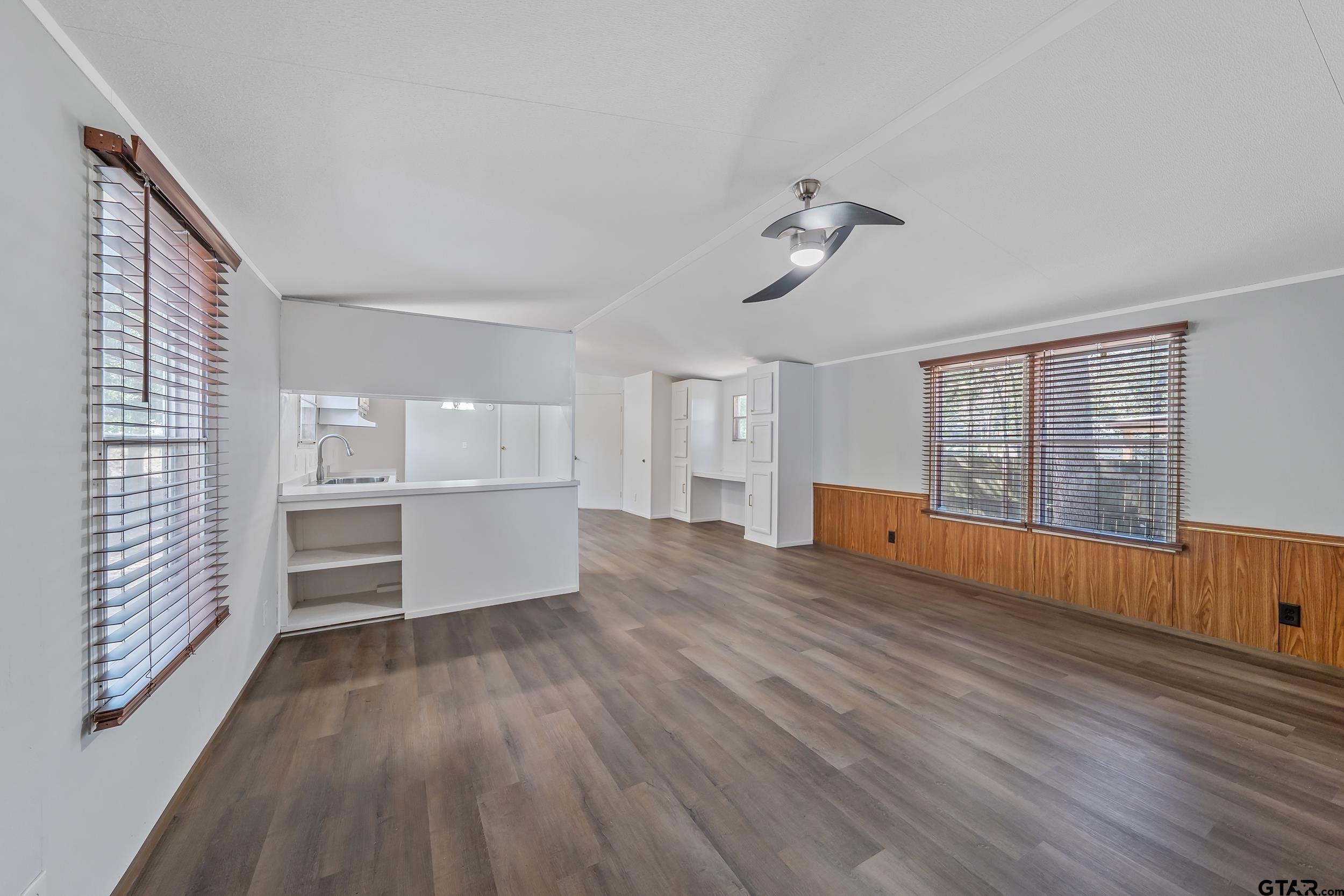 125 Ridgewood Lane Murchison, TX 75778 - Photo 12 of 46 a view of empty room with wooden floor and fan