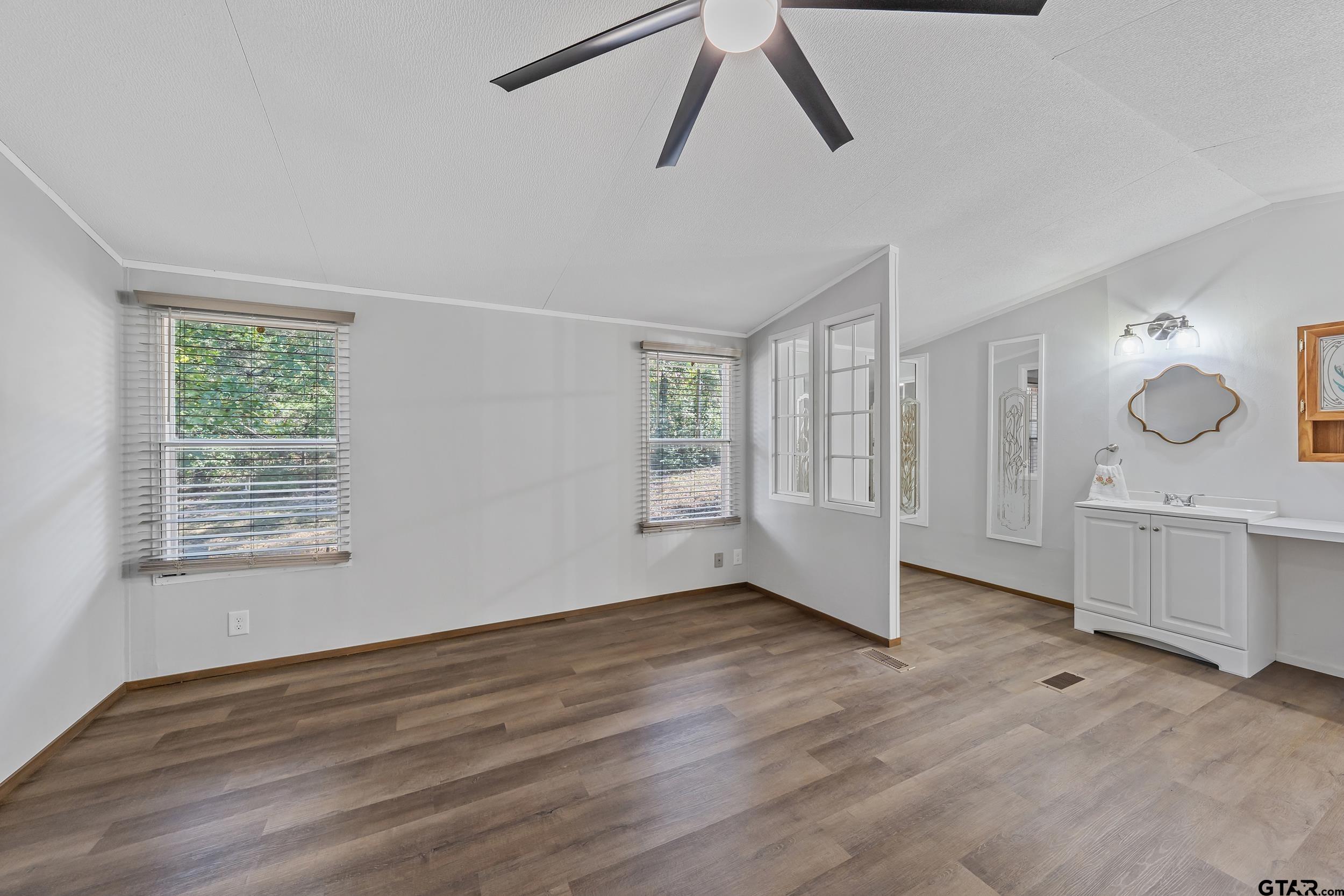 125 Ridgewood Lane Murchison, TX 75778 - Photo 16 of 46 a view of an empty room with window and wooden floor
