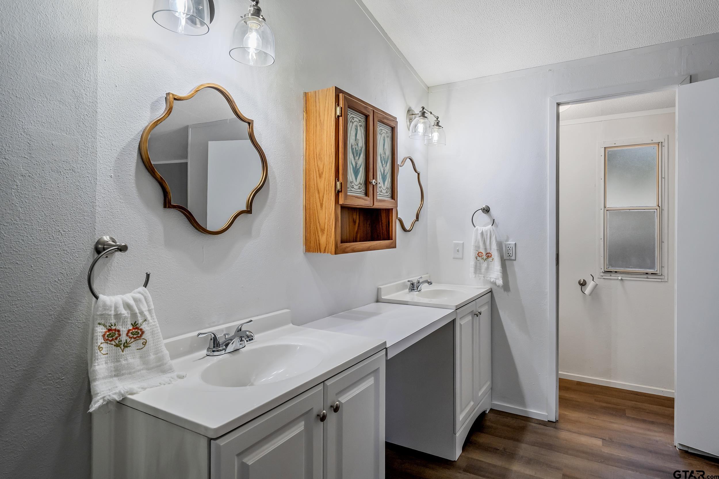 125 Ridgewood Lane Murchison, TX 75778 - Photo 17 of 46 a bathroom with a sink and a mirror