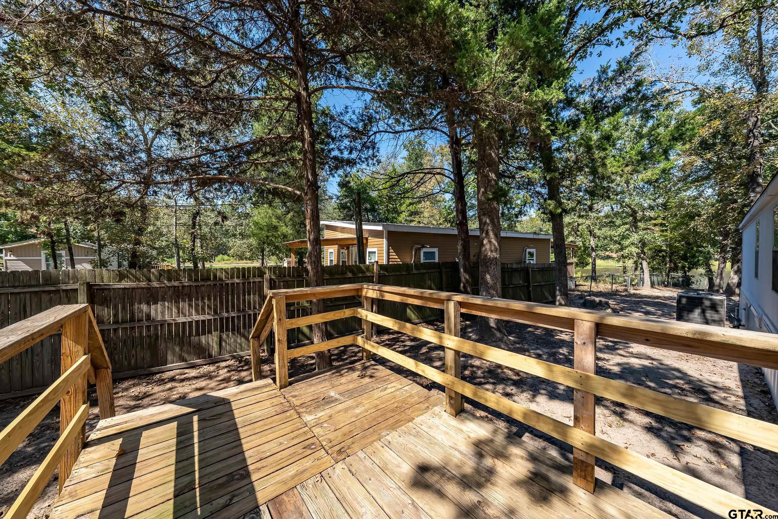125 Ridgewood Lane Murchison, TX 75778 - Photo 27 of 46 a view of a balcony with wooden floor and outdoor seating