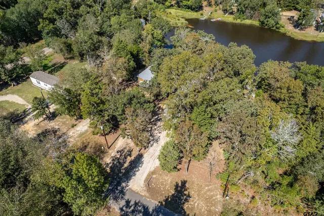 an aerial view of residential house with outdoor space and trees around