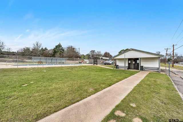 a view of a swimming pool with a yard
