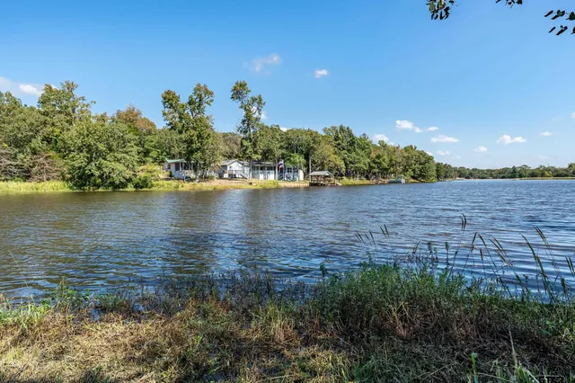 a view of a lake with houses in the back