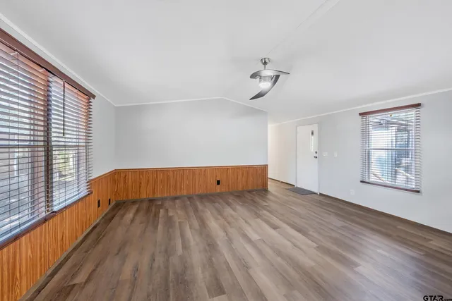 a view of room with hardwood floor and window