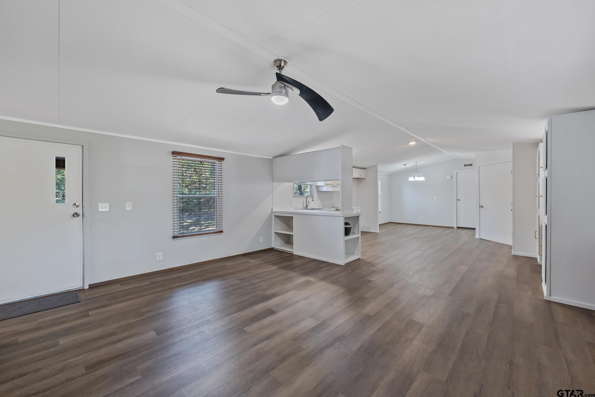 125 Ridgewood Lane Murchison, TX 75778 - Photo 9 of 46 a view of empty room with wooden floor and ceiling fan