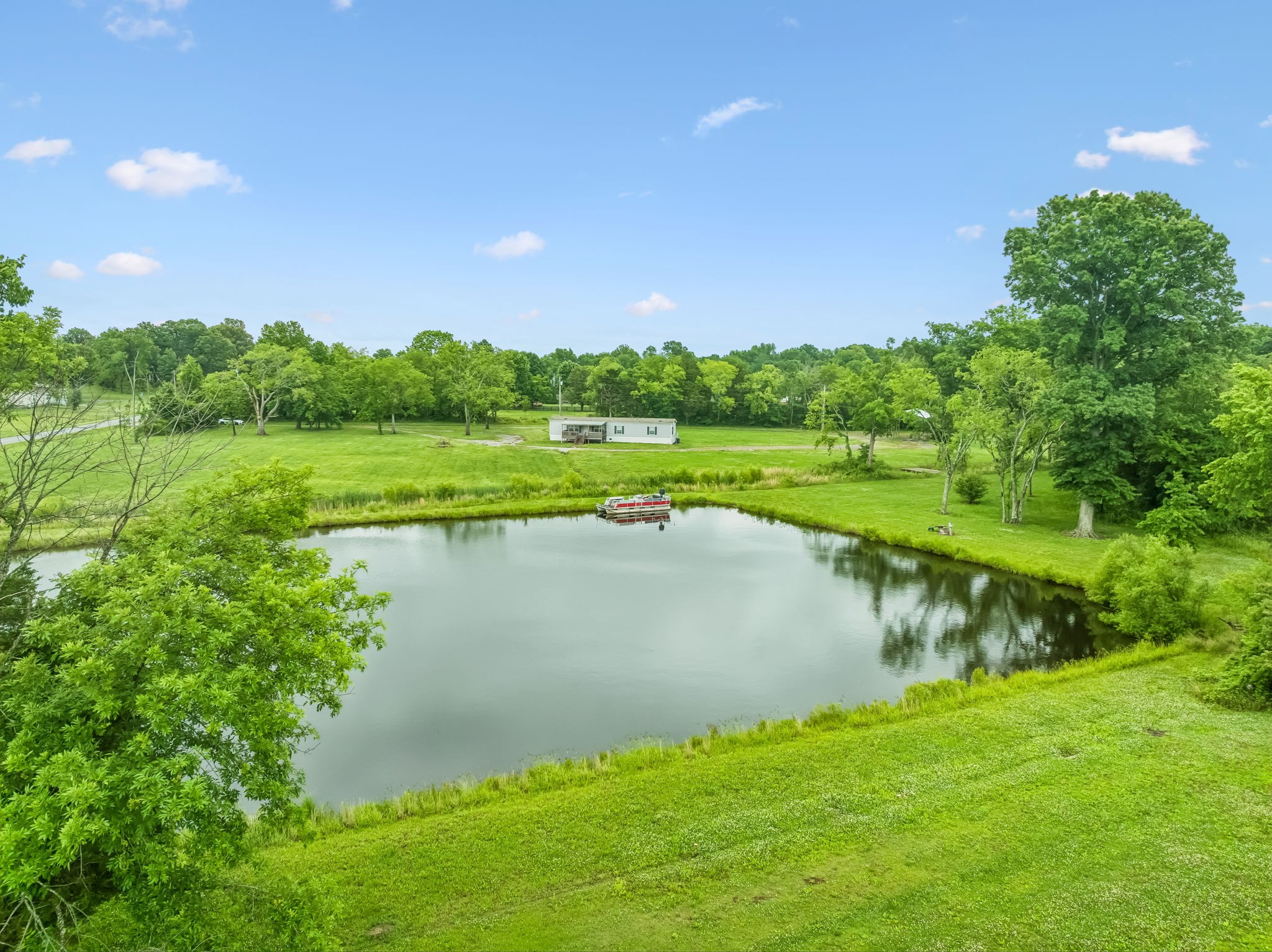 280 Kingdom Road Unionville, TN 37180 - Photo 43 of 65 a view of a lake with a yard and large trees
