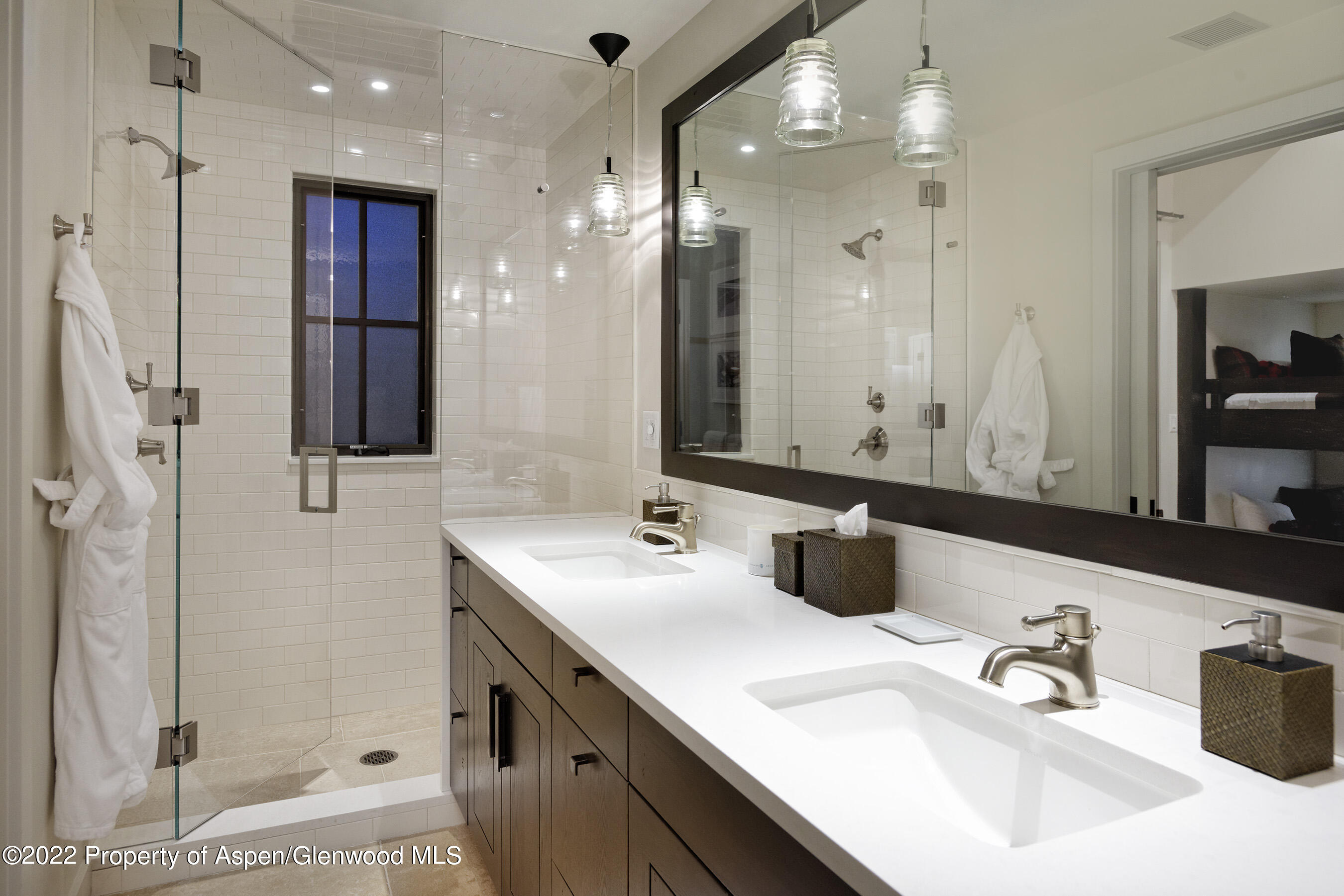 3500 Snowmass Creek Road Snowmass, CO 81654 - Photo 37 of 64 a bathroom with a double vanity sink a mirror and shower