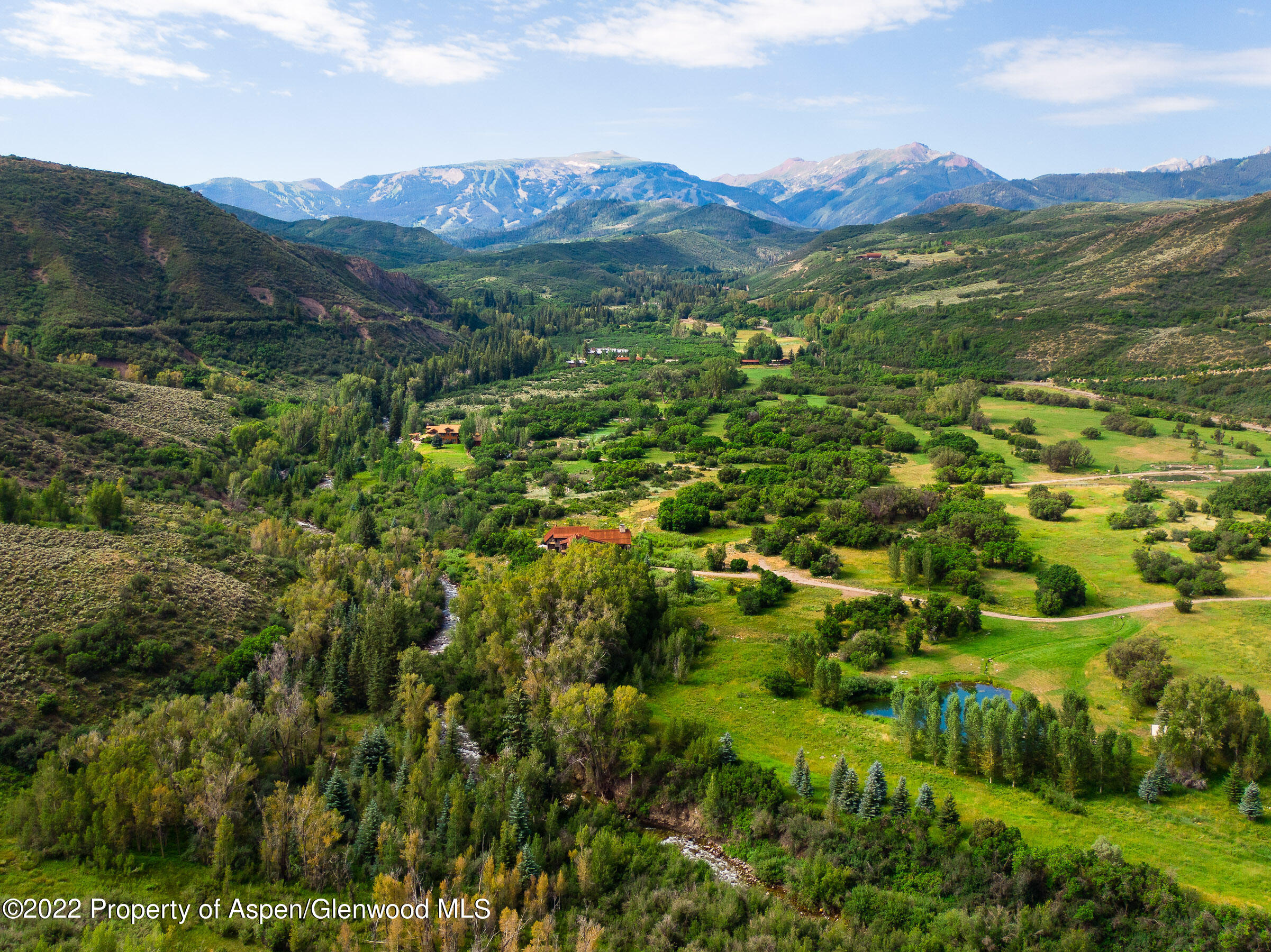 3500 Snowmass Creek Road Snowmass, CO 81654 - Photo 57 of 64 a view of a lush green hillside and houses