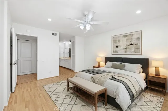 a spacious bedroom with a bed and a chandelier