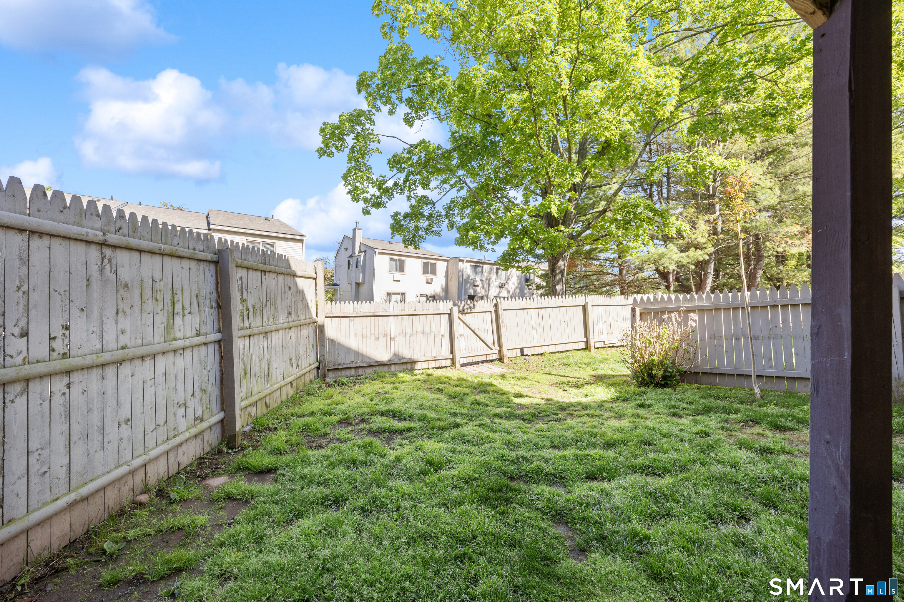 560 Yale Avenue, Unit 82 Meriden, CT 06450 - Photo 21 of 22 a view of backyard with wooden fence