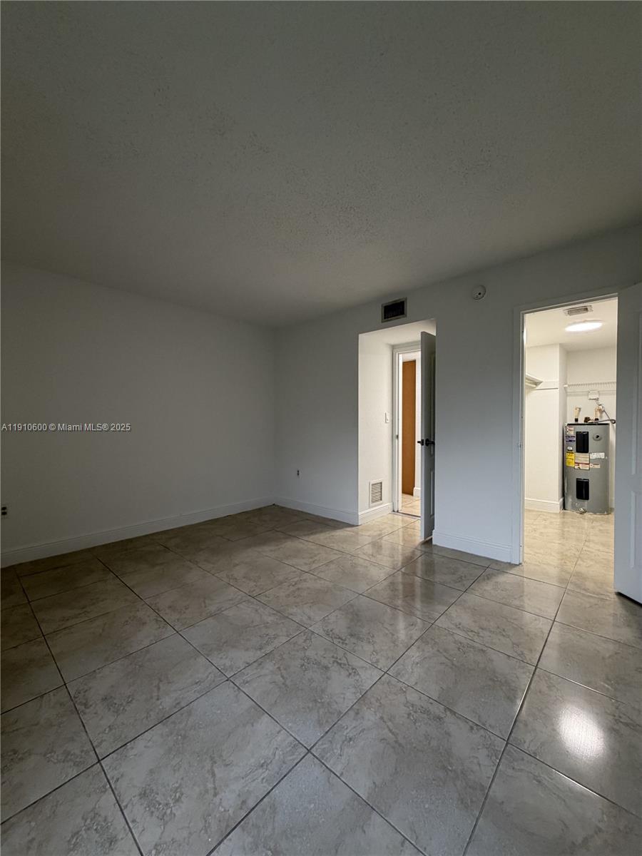 5112 Northwest 79th Avenue, Unit 304 Doral, FL 33166 - Photo 11 of 15 a view of an empty room and window