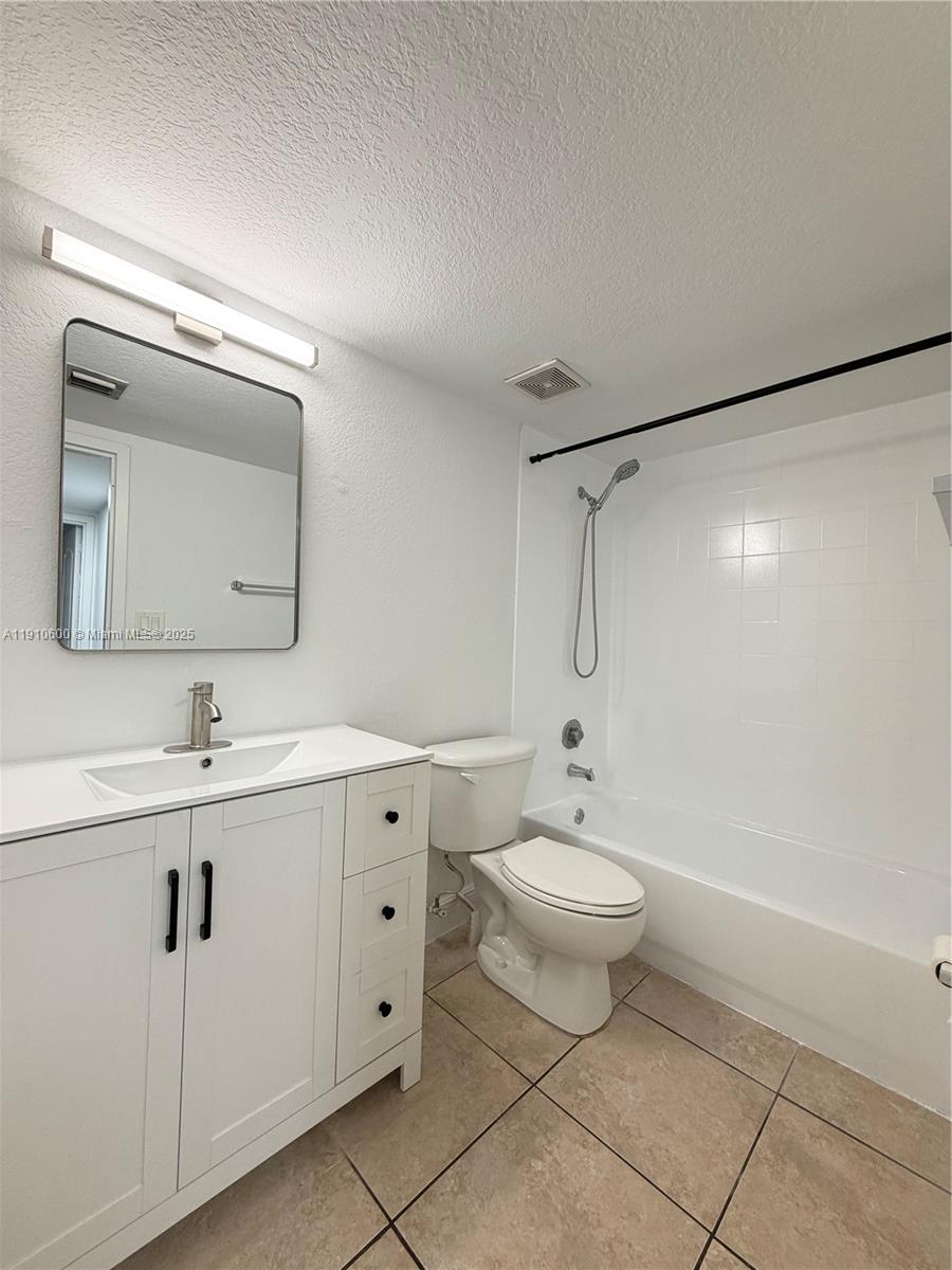 5112 Northwest 79th Avenue, Unit 304 Doral, FL 33166 - Photo 13 of 15 a bathroom with a toilet sink and mirror