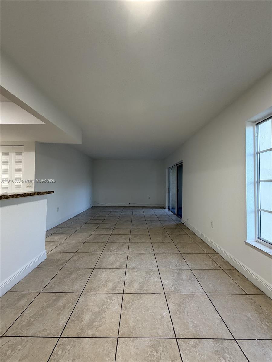 5112 Northwest 79th Avenue, Unit 304 Doral, FL 33166 - Photo 3 of 15 an empty room with windows