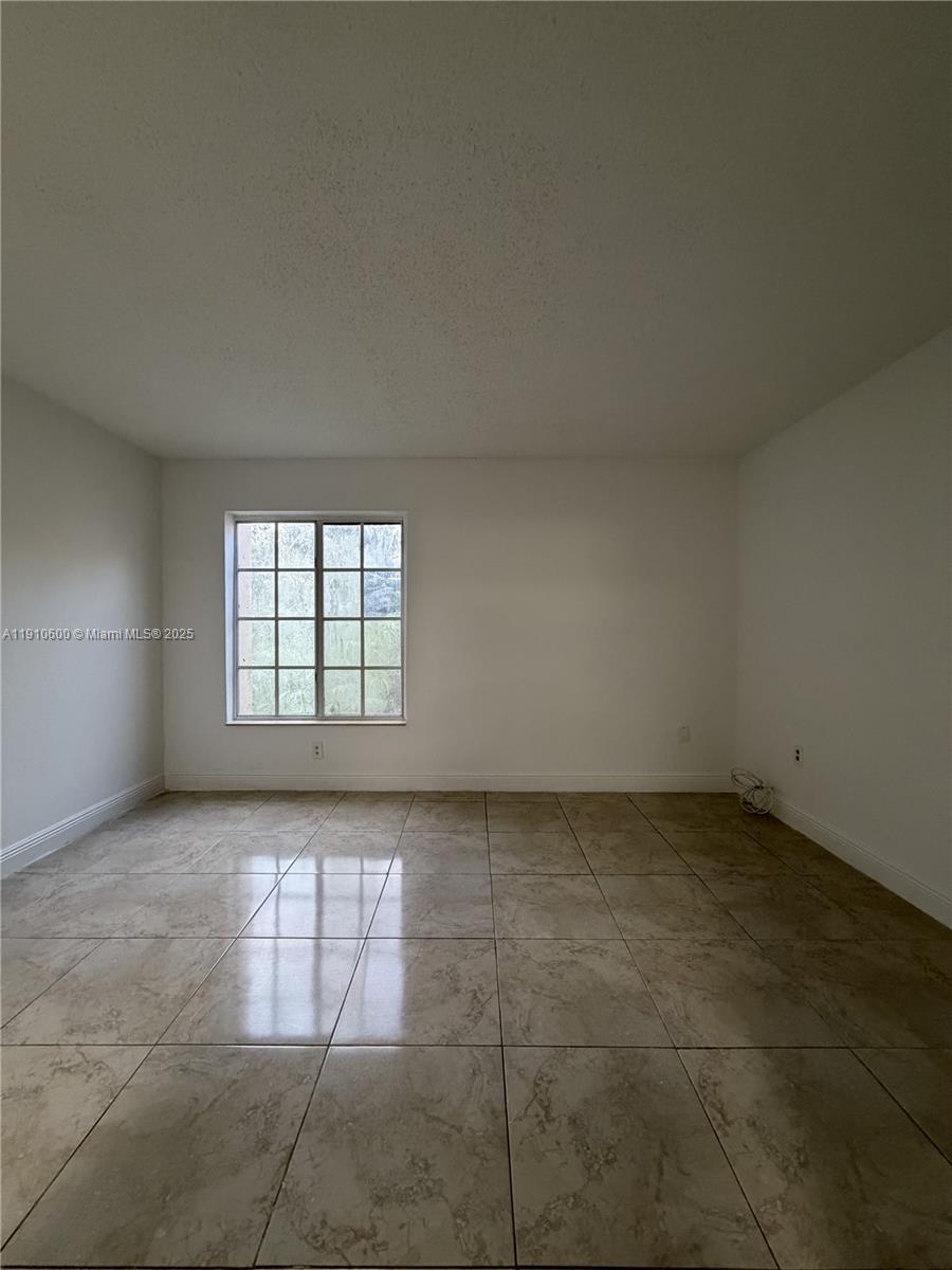 5112 Northwest 79th Avenue, Unit 304 Doral, FL 33166 - Photo 10 of 15 a view of an empty room with a window