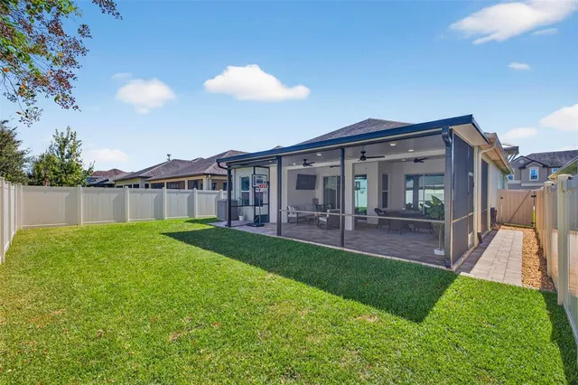 a view of a house with a backyard