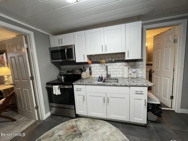 a kitchen with a sink stove and refrigerator