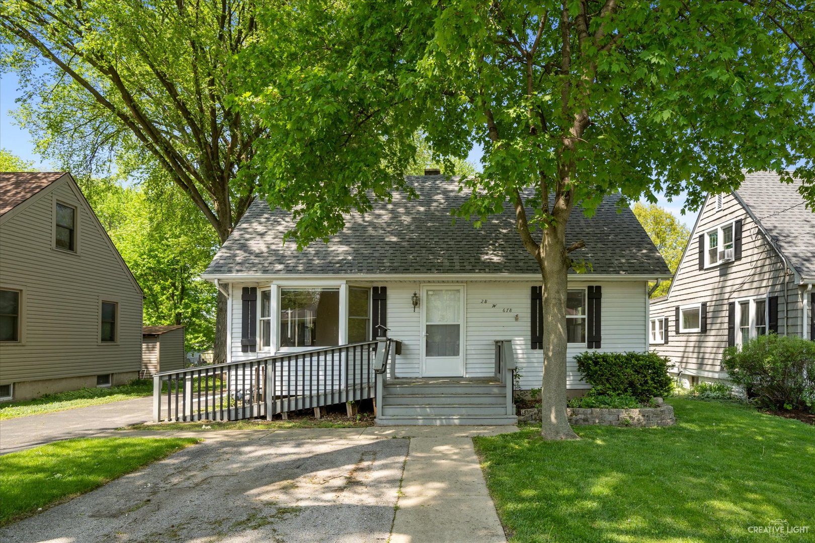 28W678 Warrenville Road Warrenville, IL 60555 - Photo 1 of 21 front view of a house with a yard