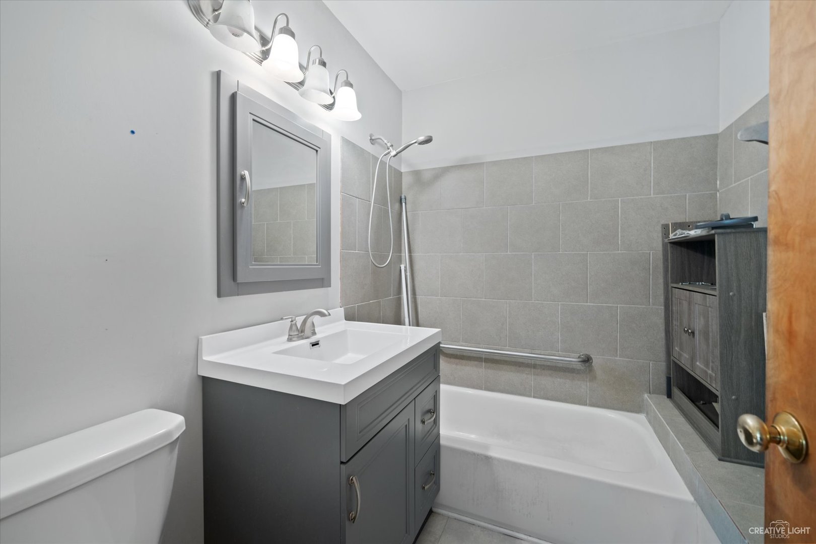 28W678 Warrenville Road Warrenville, IL 60555 - Photo 15 of 21 a bathroom with a sink toilet and shower