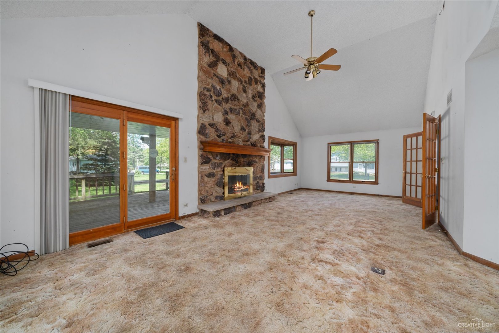 28W678 Warrenville Road Warrenville, IL 60555 - Photo 5 of 21 an empty room with windows fireplace and windows