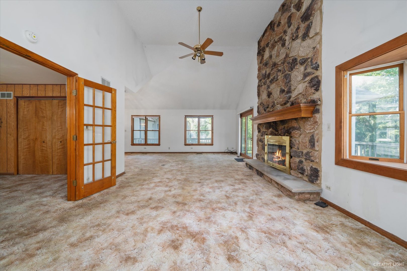 28W678 Warrenville Road Warrenville, IL 60555 - Photo 6 of 21 wooden floor in an empty room with a fireplace and a window
