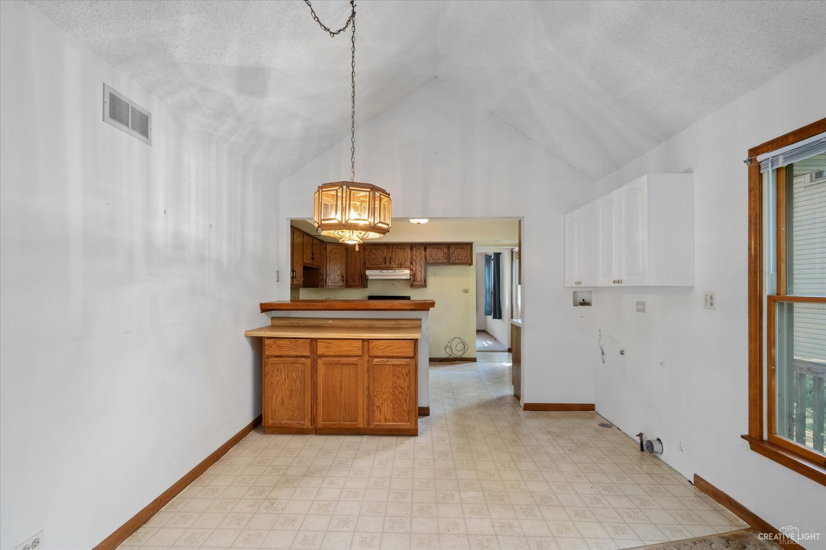 28W678 Warrenville Road Warrenville, IL 60555 - Photo 7 of 21 a kitchen with stainless steel appliances a stove a chimney a sink and cabinets