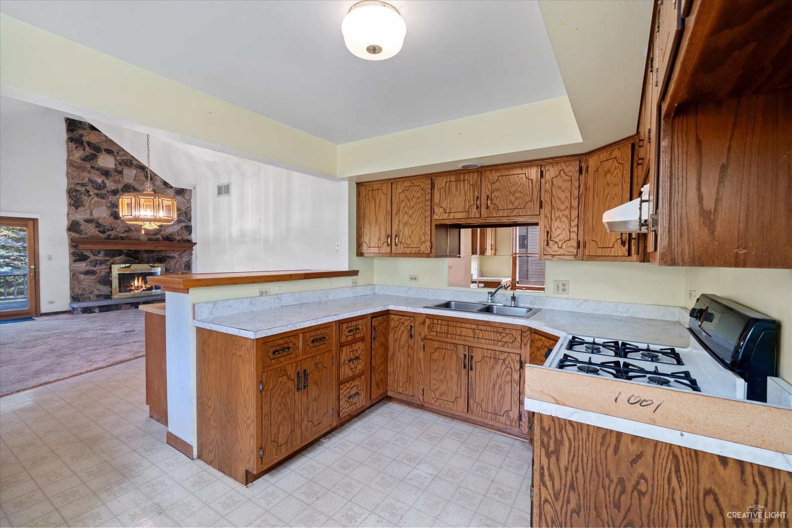 28W678 Warrenville Road Warrenville, IL 60555 - Photo 8 of 21 a kitchen with stainless steel appliances granite countertop a stove a sink and a microwave