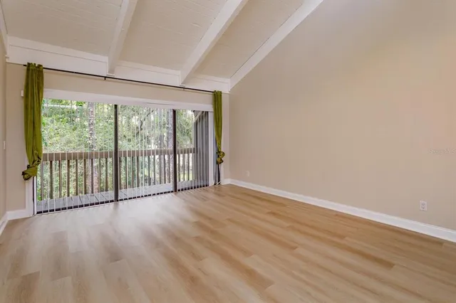 a view of a room with wooden floor