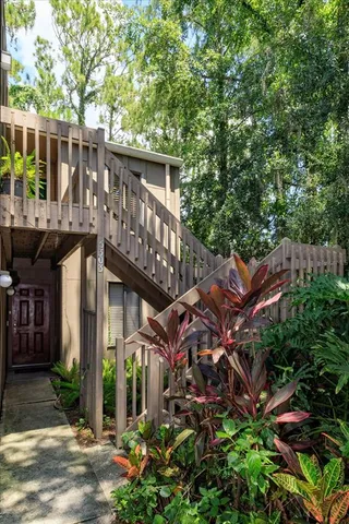 a view of a house with brick walls and flower plants