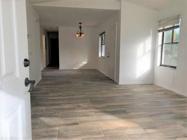 a kitchen with cabinets appliances a sink and a window