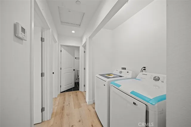 a storage room with a sink and washing machine