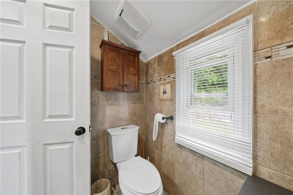 2106 Lindsay Road Pittsburgh, PA 15221 - Photo 27 of 36 The 2nd floor full bath features a double hung window overlooking the fully functional back yard.